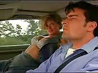 Kristy Swanson starts a down blouse stripping scene while in the car with Charlie Sheen. She exposed her big tits in a bra sat on Charlie's the lap and they made out while riding into the freeway.